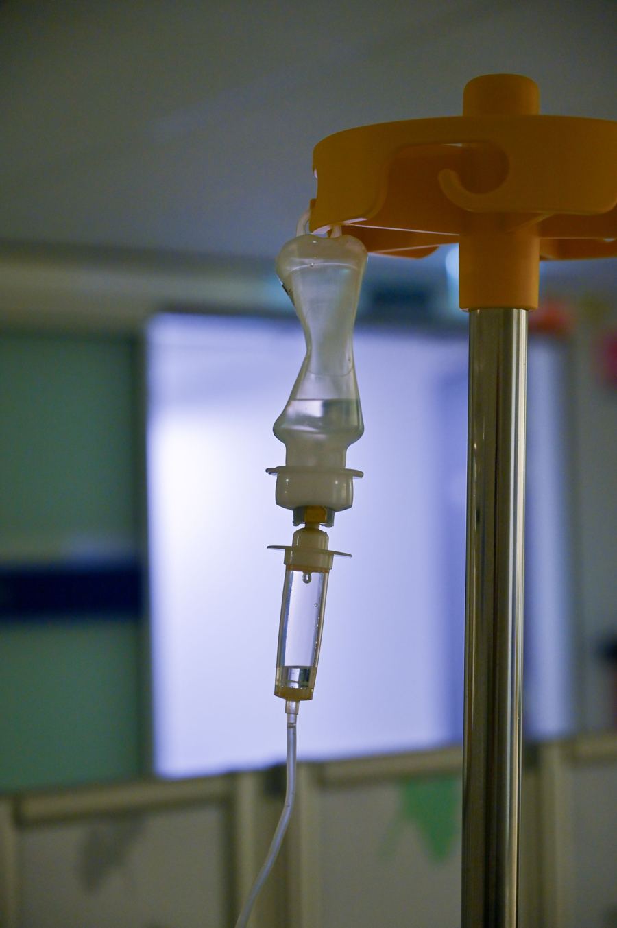 IV drip chamber and line hanging from an IV stand