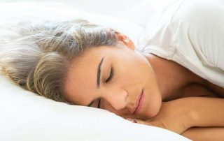 Women sleeping soundly in bed.
