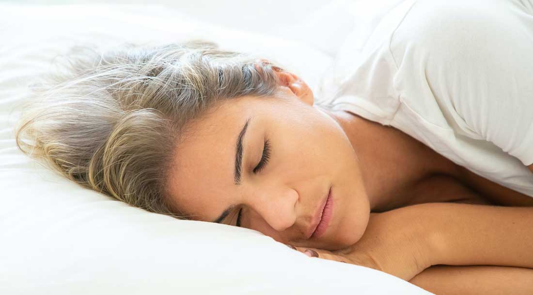 Women sleeping soundly in bed.